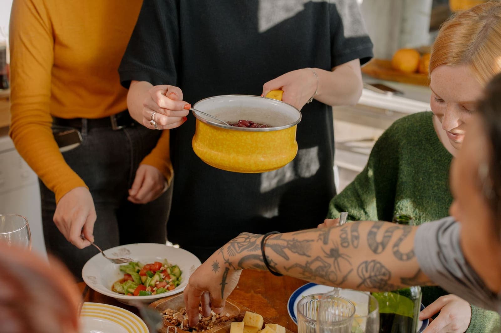 Friends sharing a home-cooked meal in a kitchen