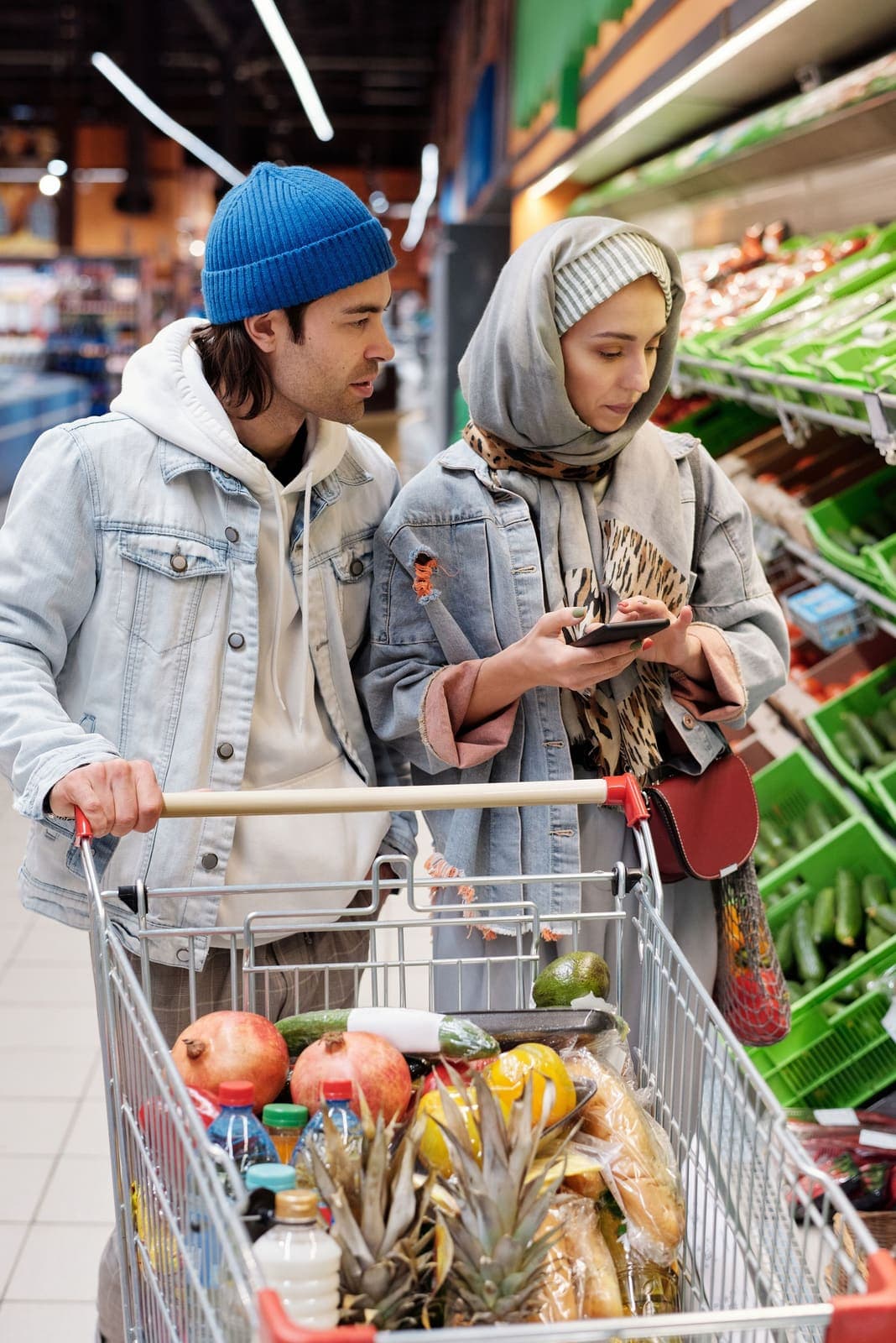 A young couple choosing groceries in a supermarket